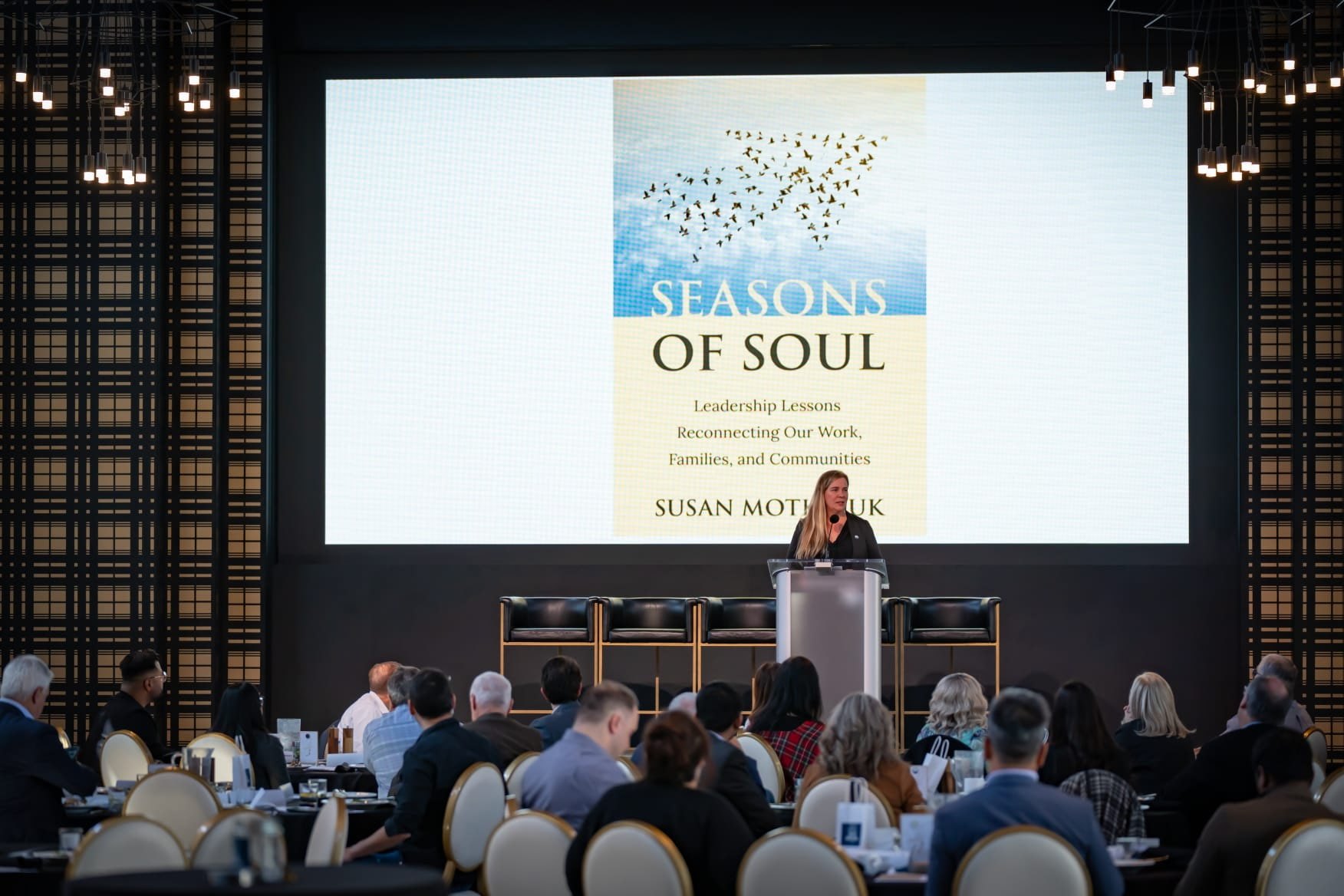 Susan Motkaluk speaking to a conference audience